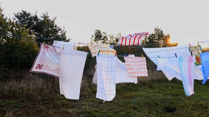 Outdoor Clotheslines with Drying Laundry during Sunset on Windy Autumn Day