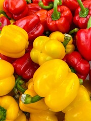 Close-up photo of sweet pepper in market. Group of vegetable background. Yellow and red sweet peppers.