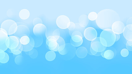 白色の玉ぼけと水色の淡い幻想的で抽象的な背景イメージ素材