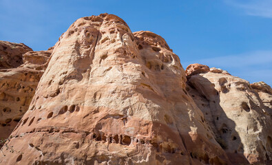 Fototapeta premium Golden sandstone geographical formations with a desert prairie landscape on a hot summer day at the Cohan Canyon Trail in Capitol Reef National Park Southern Utah.