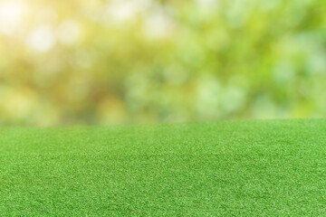 Naklejka premium Green grass field over bokeh nature background.