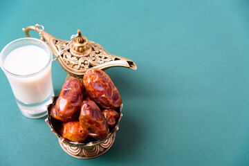 Ramadan, Dates in golden bowl, Milk, arabian Aladdin golden lamp vintage style on black green background