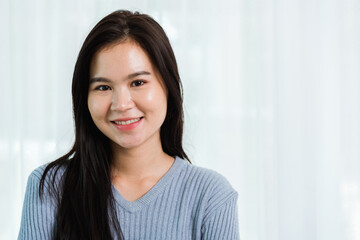 Close up headshot portrait young Asian happy beautiful woman healthy smiling face long hair, studio shot looking to camera at home and have a copy space for your text