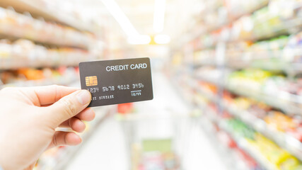 Credit card in hand shopping in malls with blurred background