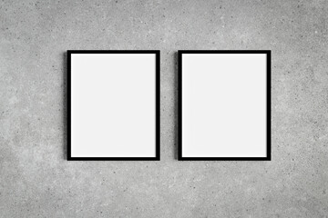 Set of two black portrait picture frame mockups on grey wall