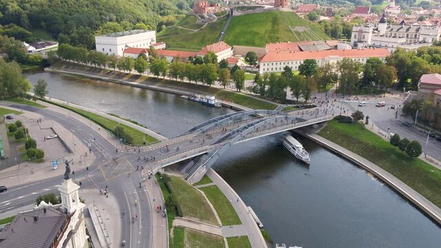 Aerial summer view of bicycle race throught the bridge in a midle of a town in Lithuania, Vilnius city