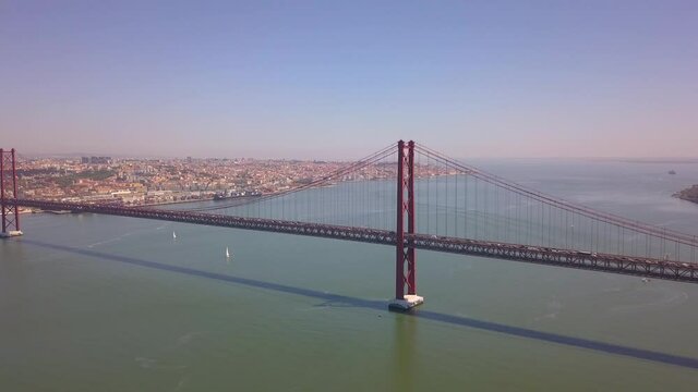 drone image of bridge 25 de abril in Lisbon Portugal, Almada view of the Capital.  side view 