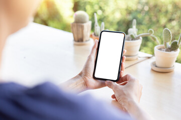 cell phone blank white screen mockup.woman hand holding texting using mobile on desk at office.background empty space for advertise.work people contact marketing business,technology