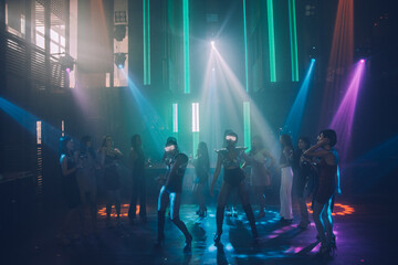 Group people women dancing in night party with DJ  EDM Music