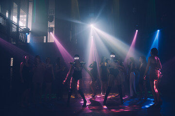 Fototapeta na wymiar Group people women dancing in night party with DJ EDM Music