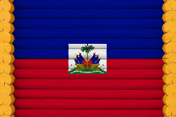 National flag  of Haiti on a wooden wall background. The concept of national pride and a symbol of the country. Flags painted on a house