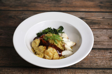 Shrimp dumpling noodles and crab meat on wood background