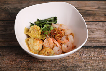 Shrimp dumpling with shrimp on wood background