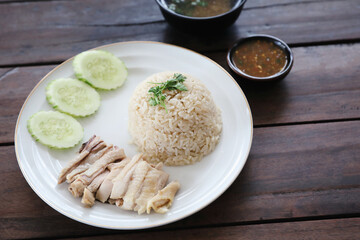 Thai food gourmet steamed chicken with rice khao mun kai in wood background