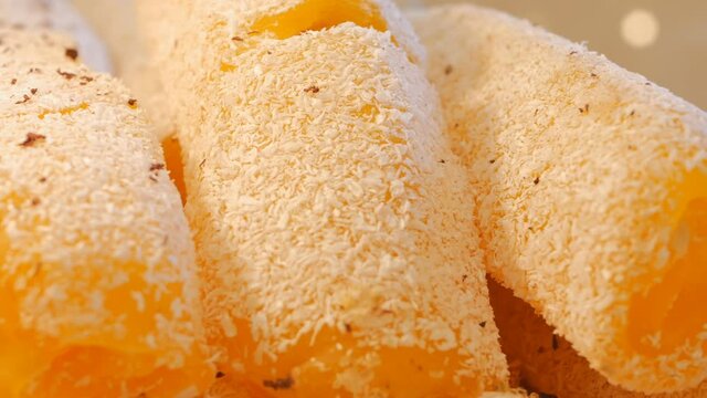 Dolly Shooting Fruit Turkish Delight with Apricot. Rahat lakum yellow with coconut chips. Dolly shooting. Close-up 4k. Ramadan