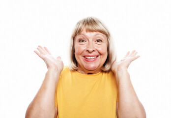 Old people, modern lifestyle, body language concept. Portrait of shocked mature woman in yellow...