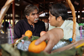 Fototapeta premium Cheerful asian senior elderly prepare alms to make a merit in temple.