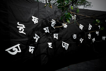 The white letters of the Bengali alphabet are Being visible in the black background. 21st February is the International Mother Language Day of Bangladesh.