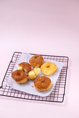 Grainy Donat or Donut or Doughnut with caramel and Lotus biscuit crumbs. Selective focus, pink pastel background