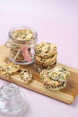 Celebration cookies, Florentine cookies in a glass jar and wooden board . Gluten free biscuits made from mixed nuts and dried fruits as a healthy choice. 