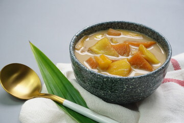 Kolak Ubi Nangka, Indonesian dessert, made from Sweet potato and Jack fruit cooked with palm sugar, coconut milk, pandanus leaves. Very popular during Ramadhan. Clean grey background