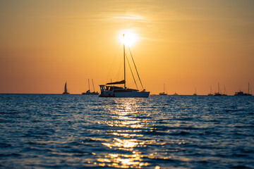 Sailing boats at Vesteys beach at sunset in Darwin, Australia.