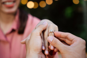 Man make a propose for marriage with engagement ring.