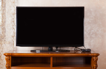 TV is off, which is located in a in the modern living room. 3d rendering. Black color tv.