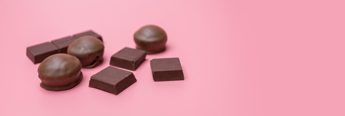 Fototapeta na wymiar Valentine dark chocolate on pink background, Valentines Day Theme, Banner background