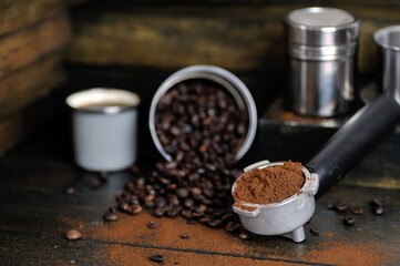 coffee bean cup and porta filter with coffee powder inside and Vietnam Drip Coffee on wooden table