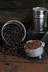 coffee bean cup and porta filter with coffee powder inside and Vietnam Drip Coffee on wooden table