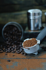 coffee bean cup and porta filter with coffee powder inside and Vietnam Drip Coffee on wooden table