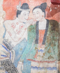 NAN, THAILAND – DECEMBER 26: Grandfather and Grandmother's curtain painting in Wat Phumin Which is a picture of whispering to love each other on DECEMBER 26 2020 in Nan, Thailand.