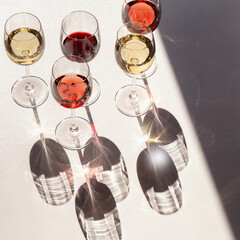 Set of wine in glasses. Red, rose and white wine. Hard light.