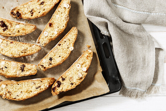 Sweet cantuccini biscuits. Homemade Italian biscotti cookies baked in oven on baking sheet.