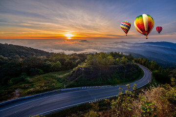 Colorful hot-air balloons flying over the mountain and sea of mist, Doi Inthanon Natural Park Chiang Mai, Thailand