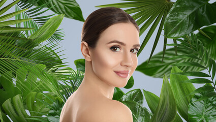 Beautiful young woman and tropical leaves, banner design. Spa portrait