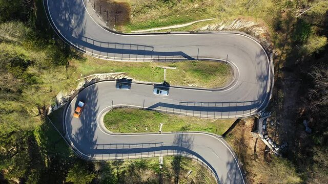 Static overhead drone footage of cars driving on the Maloja pass road in the Engadine region of Canton Graub&uuml;nden in the alps in Switzerland