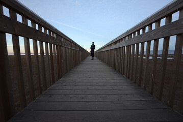 Fototapeta premium walking on wooden bridge with mask