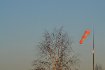 Wind direction indicator against the background of the evening sky.