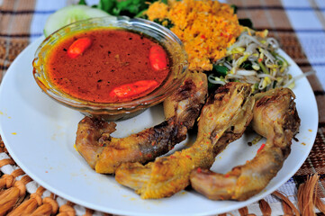 This is Ayam Bakar or Ayam Panggang. Ayam Bakar is one of the favorite dishes in Indonesia. Half-cooked chicken with spices then grilled over charcoal