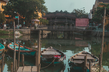 Fototapeta na wymiar Hoi An, Vietnam - 09-04-2018: Colorful view of busy street and crowded river in Hoi An, Vietnam, famous for mixed cultures and architecture. Traditional colorful lanterns spread light all around.