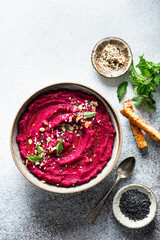 beet hummus in a ceramic bowl