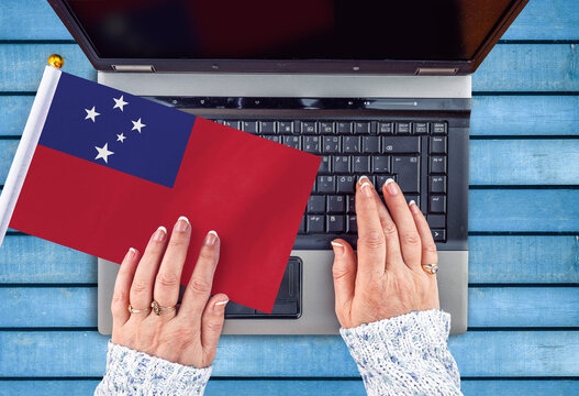 woman hands and flag of Samoa on computer, laptop keyboard  - Powered by Adobe
