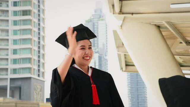 Young asian women in graduation gown outfit meeting outdoor and congratulate together from university graduated