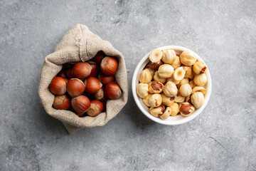 Hazelnuts peeled and in shell on gray background. Background and textures. 