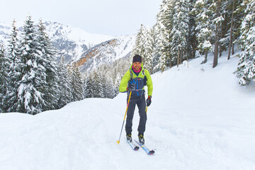 Fototapeta na wymiar Hiking ski uphill alone in the alps