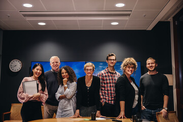 Team of television reports in meeting room