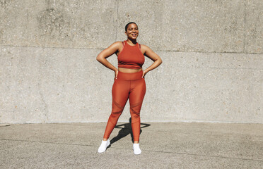 Healthy woman in sportswear standing outdoors