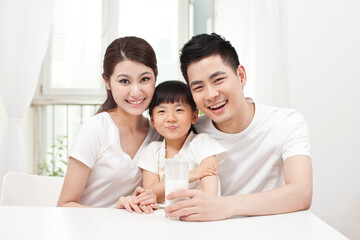 A happy family of three and milk 
